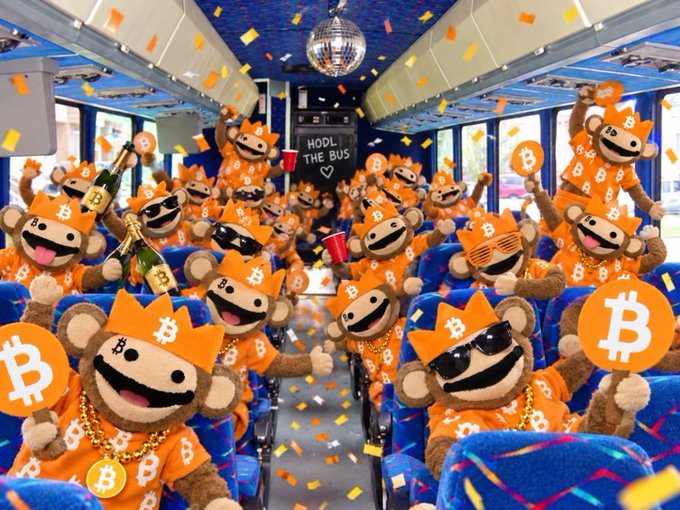 An illustration of monkey mascots wearing Bitcoin-themed orange shirts and crowns, partying inside a bus with confetti and a sign reading 'HOOL THE BUS <3'.