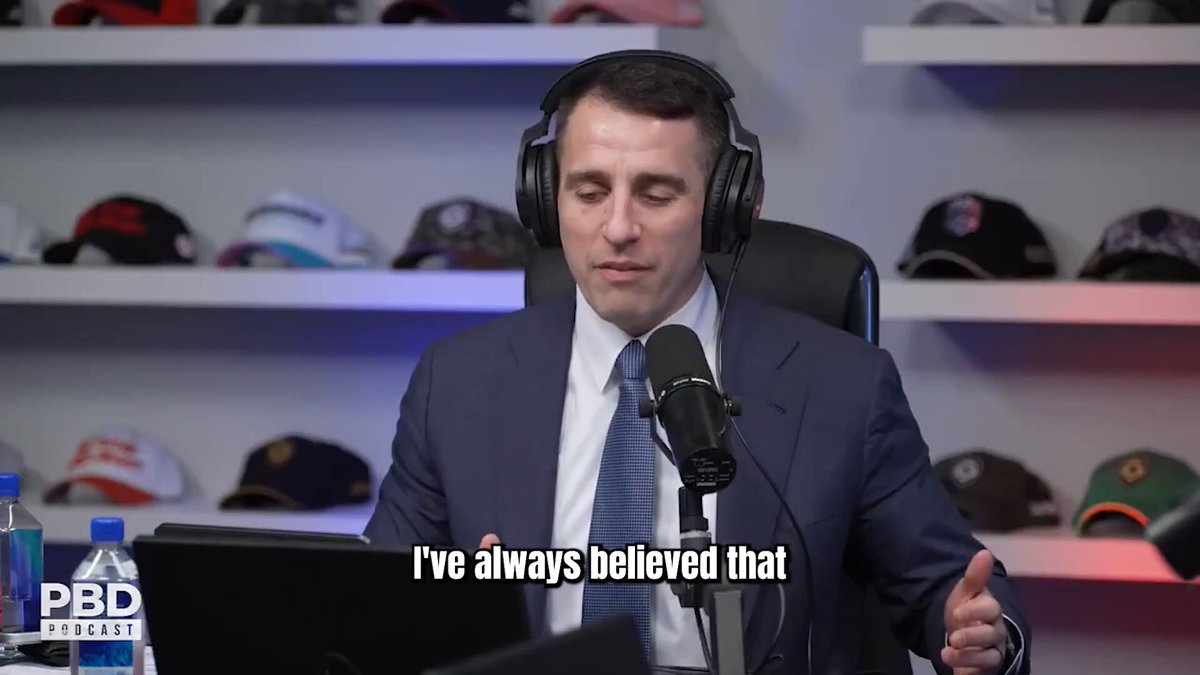 The image shows a man wearing a suit and headphones sitting at a desk with a microphone, suggesting that he might be hosting a podcast or recording an interview. The caption reads "I've always believed that...", which could be related to the topic of investing in AI, bitcoin, new IPOs, or other opportunities. This statement implies that the man has strong opinions on these subjects and wants to share his views with others through his podcast or radio show.