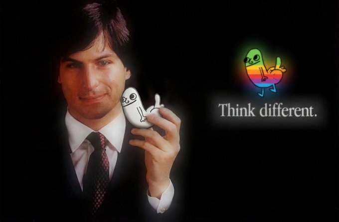 An image of Steve Jobs holding an Apple mouse with a cartoon figure and the text 'Think different.'