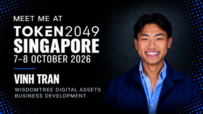A promotional graphic announces 'MEET ME AT TOKEN2049 SINGAPORE 7-8 OCTOBER 2026' featuring a smiling man identified as 'VINH TRAN, WISDOMTREE DIGITAL ASSETS BUSINESS DEVELOPMENT'.