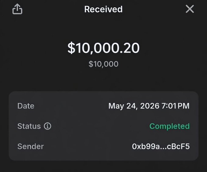 The image shows a black screen displaying a message about a wallet transfer of $10,000.00. The text indicates that the wallet has been completed and is ready for pickup at 7:01 PM. The wallet address is provided as "0x9b99a...".