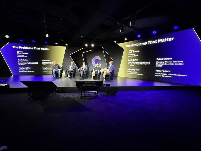 A panel discussion on stage titled 'The Problems That Matter' featuring speakers Chris Zook, Judith Dotan, Horyung Chai, Brian Shedd, Tony Pecore, and Tony Pecore (SVP & Director of DA Management, Franklin Templeton).