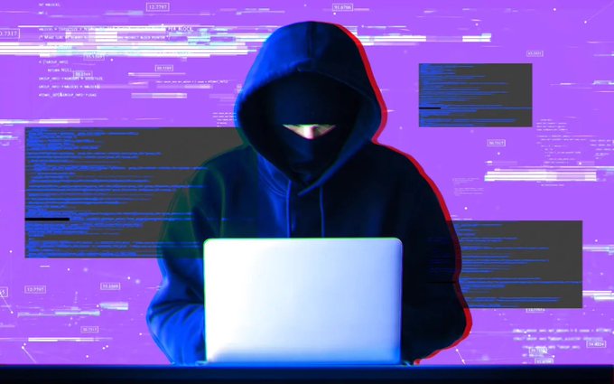 A hooded figure wearing a black mask types on a glowing laptop against a purple background with digital code overlays.