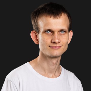 A clean headshot of a young man with short brown hair wearing a white t-shirt against a dark background—appearing to be Vitalik Buterin, the Ethereum co-founder referenced in the post about his anonymity being uncovered.