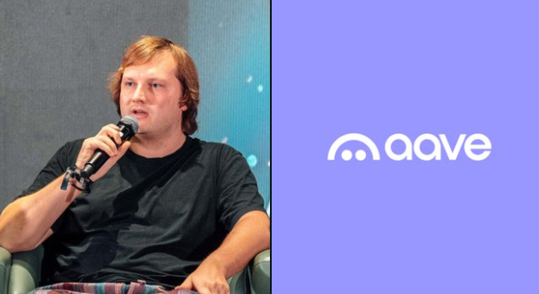 A man with reddish-brown hair, identified in the context as Aave founder Stani Kulechov, speaks into a microphone while seated at what appears to be a panel discussion, next to the "aave" logo on a purple background. The image accompanies a post about Kulechov addressing rumors of selling $AAVE at a discount and teasing Aavenomics 3.0.