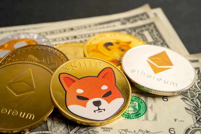 A close-up of physical Shiba Inu ($SHIB) and Ethereum (ETH) cryptocurrency tokens displayed atop U.S. dollar bills, visually representing the significant exchange outflow and accumulation trend described for $SHIB. The presence of the Shiba Inu coin directly symbolizes the meme coin at the center of the post's discussion about large holders pulling tokens off exchanges.