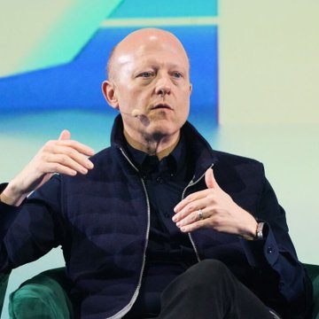 Circle CEO Jeremy Allaire speaks at a conference, gesturing with his hands while wearing a dark zip-up jacket, as he discusses the future of the CLARITY Act following its failed Senate vote.