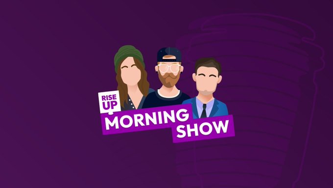 The image features a purple background with three cartoon-like faces, each wearing sunglasses and hats, positioned above the text "Rise Up Morning Show" written in white letters. Below this, there's a small logo for a cryptocurrency called "solana". The text "our official meme token $RISEUP has officially launched! @solana CA: CqMF1Gn52r96rxsSPy3u3KAeia9JyMJJWVczXCApump pump.fun/coin/CqMF1Gn52" is written in white letters, and the text "Solana" is also written in white letters below it.