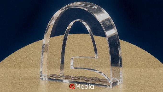 A clear acrylic decorative piece resembling an archway with coins inside, branded with 'RC Media' logo.