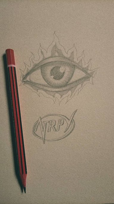 A pencil sketch on tan paper featuring a flaming eye design above the letters 'NTRP' enclosed in a circle, with a red mechanical pencil resting beside the drawing.