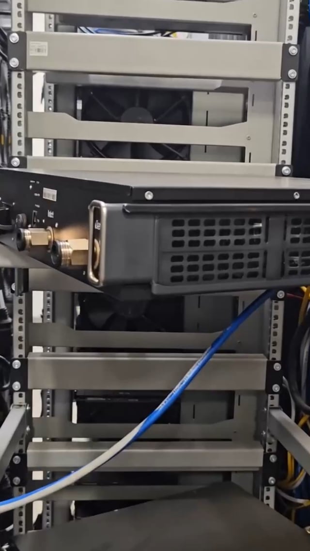 The image shows a computer server rack with various electronic equipment, including a black box labeled "Litecoin ETF" that is connected to the server by blue cables. The server appears to be part of a larger network or infrastructure, possibly used for mining cryptocurrency like Bitcoin and Ethereum. The post also mentions that one can mine LTC and DOGE simultaneously on this server, which could be an interesting feature for those interested in exploring different cryptocurrencies.

The image is taken from the side, providing a clear view of the server rack's structure and the cables connecting it to other equipment or servers within the network.