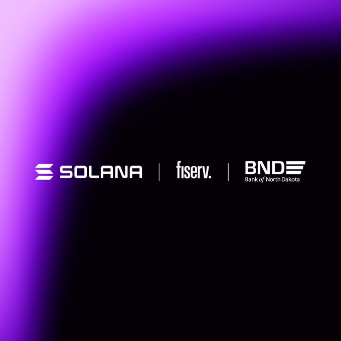 A sleek purple and black graphic displays the logos of Solana, Fiserv, and BND (Bank of North Dakota) side by side, illustrating the partnership behind Roughrider Coin—the state-issued stablecoin now processing real-time transactions on Solana's blockchain through Fiserv's digital asset platform.