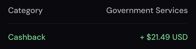 A dark-themed app interface showing a transaction summary with 'Category' listed as 'Government Services' and a green 'Cashback' amount of '+ $21.49 USD'.