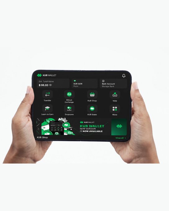 Two hands hold a foldable smartphone displaying the 'KUB WALLET' app interface, showing a total value of $99.53 and various menu options including Transfer, Bikubit Exchange, KUB Shop, Vote, Learn to Earn, Dropzone, KUB Stake, and More.