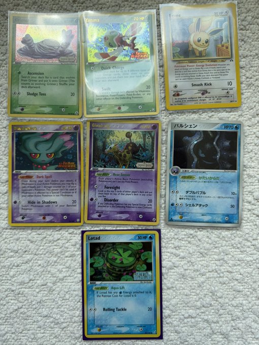 A collection of seven Pokémon trading cards displayed on a carpet, including stamped variants like Sizzlipede (HP 70), Yamna (HP 70), Sentret (HP 50 HP), Misdreavus (HP 60), Foresight, Swirlix, and Lotad (HP 50), alongside Japanese cards. The post references collecting decent "Kusube" (likely meaning vintage or Japanese) cards while replacing non-stamped Komiya's with their stamped versions for fun and affordability.