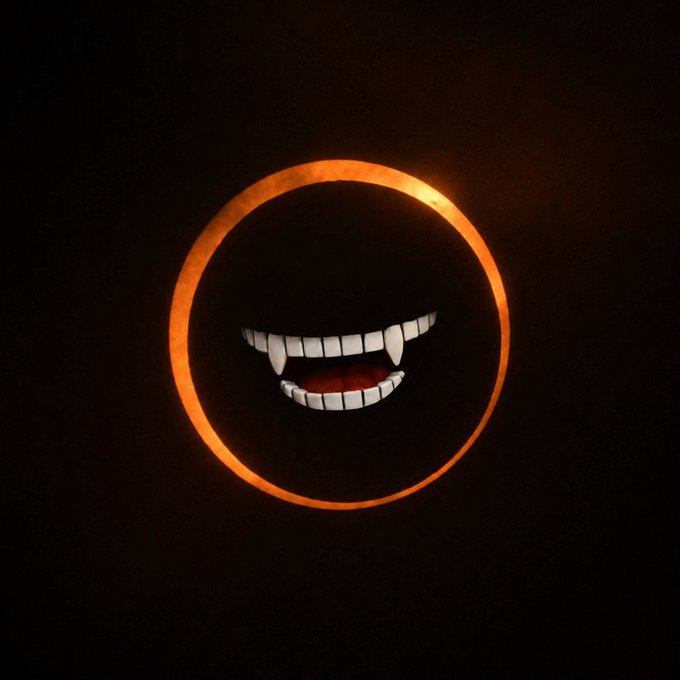 A dark image featuring an orange glowing circle with menacing vampire fangs and a red mouth inside it.