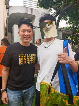 CEO Richard Teng, wearing a black "BINANCE" t-shirt, poses for a photo with Korean influencer Sibal, who has his face partially covered by a mask, during an outdoor event. The image captures a meetup moment between the Binance executive and the Korean community member, tying back to the post's mention of BNBChain engaging with local crypto personalities.