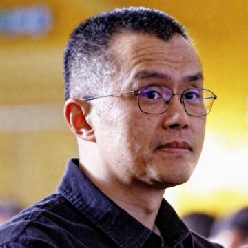 The image features a man wearing glasses with short hair and a blue shirt. He appears to be looking off into the distance or deep thoughtfully. The caption above him reads, "CZ Binance said, 'US banks are buying Bitcoin.' Next bull market will be wild!'" This suggests that there is an ongoing discussion about the potential impact of Bitcoin on the US banking system and the future of the financial markets.

The man's thoughtful expression could indicate that he is contemplating the implications of this statement or considering how it might affect his own investments in Bitcoin or other cryptocurrencies. The image captures a moment where the man's focus is directed away from the viewer, creating an interesting visual dynamic.