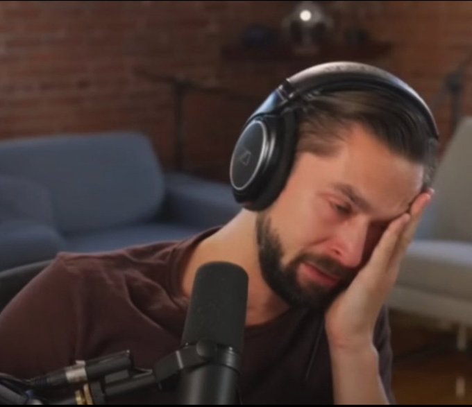 The image shows a man wearing headphones sitting down in front of a microphone at home or in an office, possibly preparing for a podcast recording session. The man has his hand resting on his head, suggesting he might be deep in thought or feeling overwhelmed by something related to the ongoing recording. The post also mentions Bitcoin, which is worth noting as it could potentially be relevant to the topic of this particular recording. However, since it's a captivating image and does not provide any additional information about the content of the podcast or its theme, it focuses more on the man with his headphones at home rather than being directly related to the main discussion in the post.