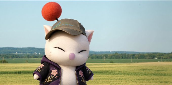 The image shows Moogle, a character from the Final Fantasy series, depicted as a cute white cat-like creature with a red pom-pom on its cap, smiling with closed eyes while wearing a purple hoodie in a sunny field.

The caption likely ties to the post about the trading/finance market, where "Moogle" humorously references a meme stock ticker or symbol, and the post congratulates followers for surviving a volatile market without their portfolio "exploding" — aligning with Moogle's iconic catchphrase "Kupo!" which resembles the username "gKupo."