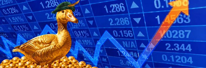 A golden duck statue wearing a green beret sits atop a pile of gold coins against a blue stock market background featuring rising chart lines and financial figures like 1.286, 2.286, and 1.4563. The image serves as a banner for the Robinhood token $GG on Moby, using the "golden goose" motif to symbolize wealth generation and crypto gains.