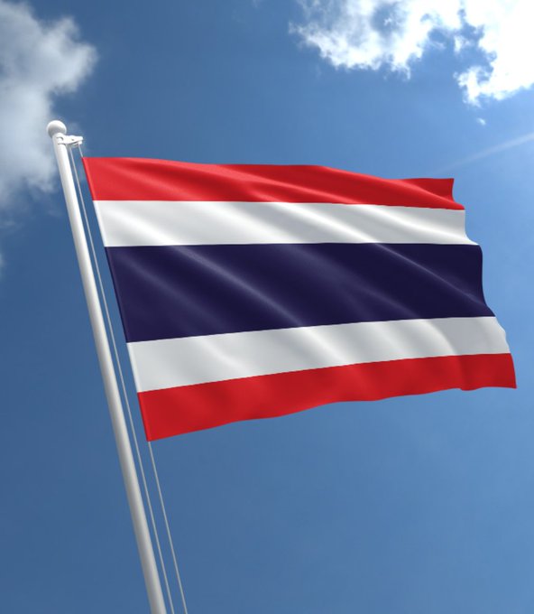 A red, white, and blue striped flag of Thailand waves against a bright blue sky with scattered clouds, symbolizing the country referenced in the news about its SEC finalizing rules for Bitcoin and Ethereum ETFs to begin trading on October 16.