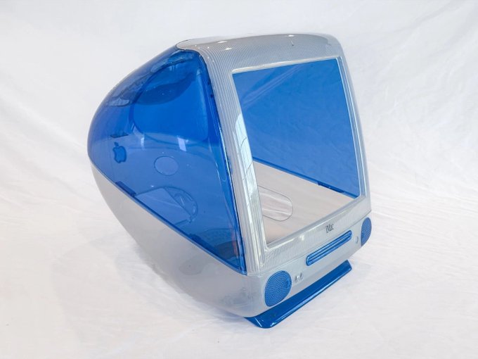 The image features a blue and white computer monitor, which appears to be an older model or a toy version of the Apple desktop computer. It has a unique design with a curved shape that resembles a shell-like structure. The monitor's color scheme is predominantly blue and white, giving it a futuristic appearance. The post in the image reads "lite node shell", possibly referring to the type of computer architecture used in this particular model or its intended purpose.