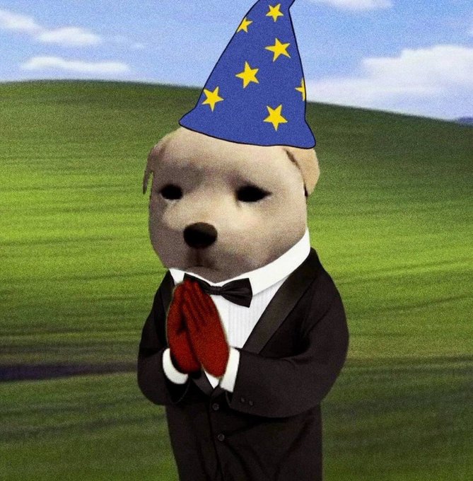 The image features a cartoon dog wearing a suit, hat, and bow tie, standing against a green field with hills in the background. The dog appears to be dressed up for a special occasion or event, possibly a party or celebration.