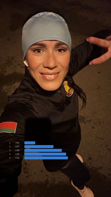 A selfie of a woman in athletic gear and a light blue cap smiling after a workout, with overlaid bars showing split times for five segments.