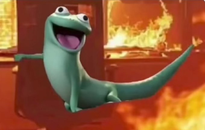 An animated green lizard-like creature smiles widely with arms outstretched against a fiery orange background with flames.