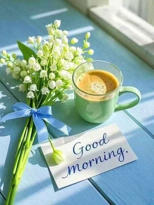 The image features a blue wooden table with a bouquet of white flowers and a cup of coffee sitting on top, accompanied by a note that reads "Good morning." The message encourages people to embrace cryptocurrency as an inclusive and accessible financial tool for everyone, regardless of their prior knowledge or experience in the field.