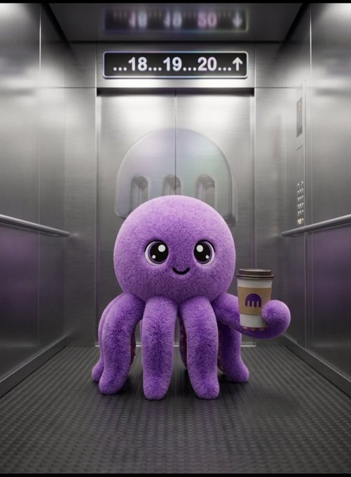 A purple, fuzzy octopus with large cartoon eyes stands in a metallic elevator, holding a McDonald's McCafe coffee cup in one of its tentacles.