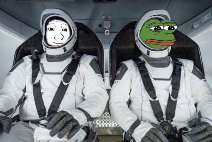 Two seated figures in white astronaut suits, one with a drawn human-like face and the other with the green Pepe the Frog face, strapped into what appears to be a spacecraft or capsule cockpit.