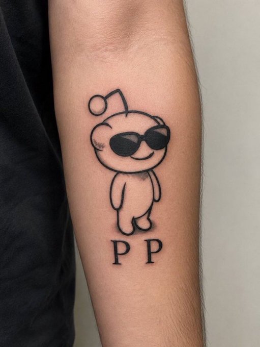 A small black tattoo on someone's arm depicts a cartoonish figure with an antenna, wearing sunglasses, with the letters 'PP' underneath.