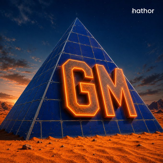A digital artwork of a dark pyramid with glowing orange "GM" letters on its face, set in a desert landscape under a starry sky with "hathor" text in the corner.