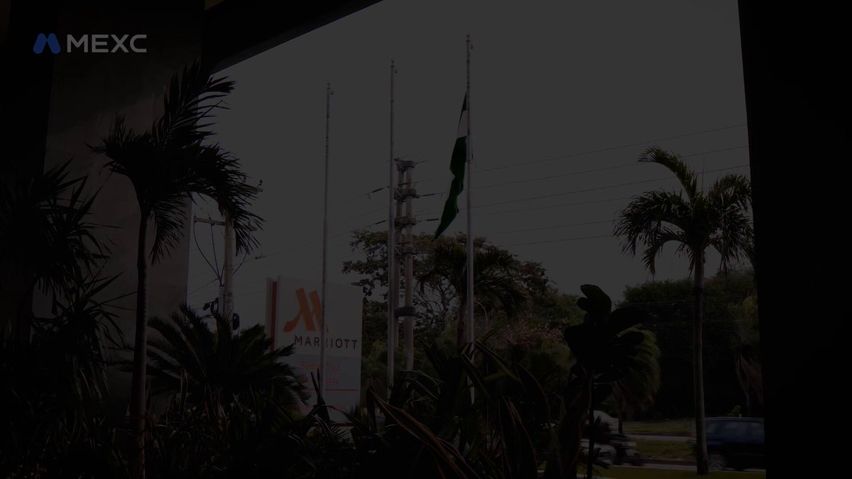 The image shows a view of palm trees with a sign that says "MEXC" above them, indicating that the location might be related to cryptocurrency or the Mexican exchange market. The photo also features a pizza missing from its box on top of a table in front of it. The caption suggests that MEXC is interested in expanding their reach into Mexico and wants to know where they should go next.