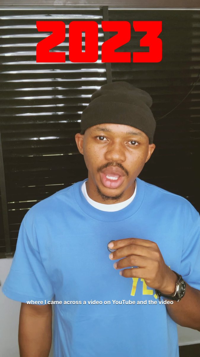 A young man wearing a blue shirt and black beanie stands indoors beneath red text reading '2023,' with a subtitle stating 'where I came across a video on YouTube and the video.'