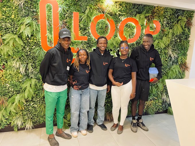 Five young people pose together in front of a green plant wall featuring the large orange "LOOP" logo, with some wearing "Loop" branded apparel. The caption celebrates their team winning the LOOP Hackathon, which was highly selective in Nairobi, with sponsors including Web3Clubs and NCBA Bank Kenya.