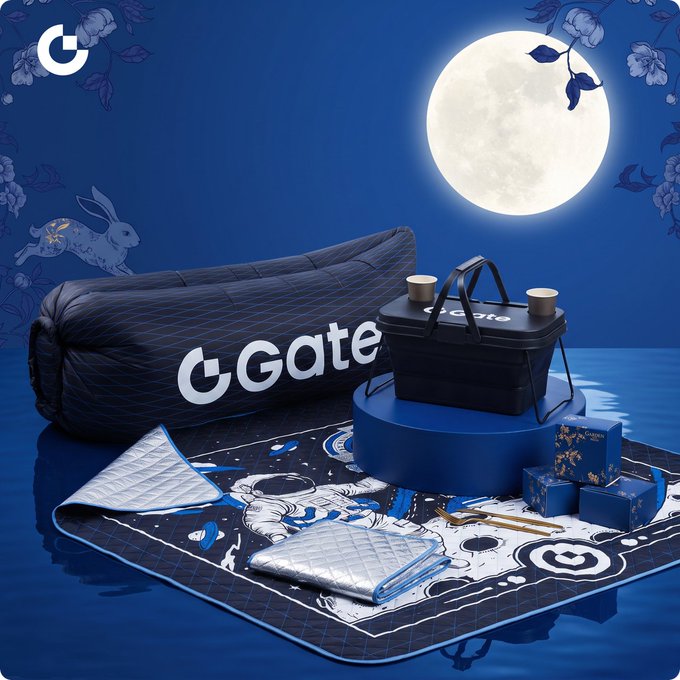 A promotional image for Gate.io featuring a Midnight Festival gift box set under a full moon, including a branded duffel bag, cooler bag, picnic mat, and other merchandise in a blue color scheme with rabbit motifs.
