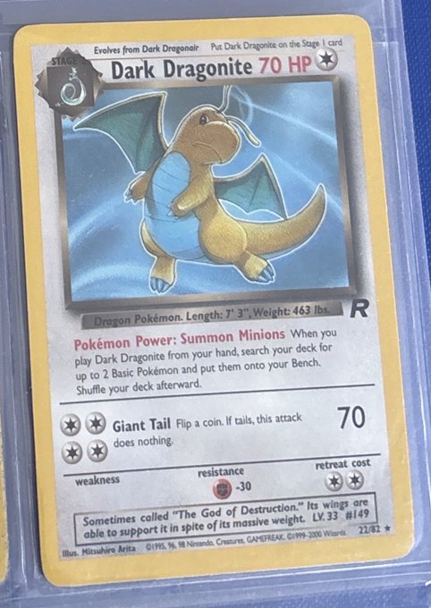 A Pokémon trading card named 'Dark Dragonite' with 70 HP, a Stage 1 card that evolves from Dark Dragonair, with attacks 'Summon Minions' and 'Giant Tail'.
