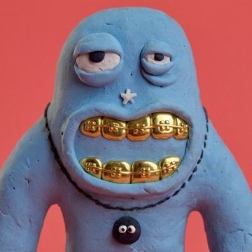 A close-up of a blue clay figurine figurine with a quirky face, droopy eyes, a small white star on its nose, and gold-painted grills on its teeth, set against a red background.
