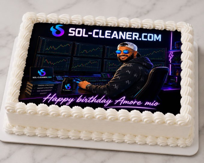 A custom birthday cake featuring an edible image print of a bearded man wearing sunglasses and a cap, seated at a trading workstation with multiple monitors displaying charts. The print includes the branding 'SOL-CLEANER.COM' at the top, a logo with bullet points listing services like 'TRADING STRATEGIES, MARKET STRUCTURE, RISK MANAGEMENT, SNIPERS,' and the message 'Happy birthday Amore mio' in pink neon-style script.