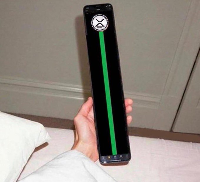 A hand holds an unusually long, rectangular black device with a green vertical stripe and a "Half Life" lambda logo on the screen.