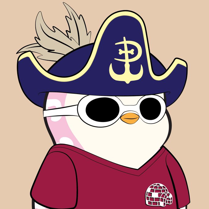 A cartoon illustration of a penguin character wearing a navy pirate captain hat with a gold emblem and feather, black sunglasses, and a maroon shirt with a small igloo logo on the chest.