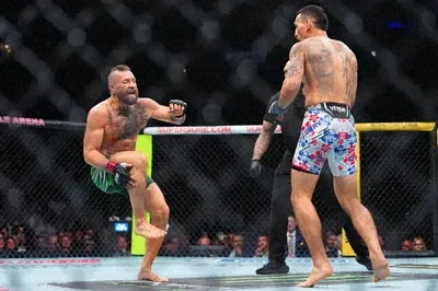 Two UFC fighters face off inside the cage, with one throwing a punch toward his opponent in colorful shorts, while a referee in the background watches. The image metaphorically illustrates the accompanying post's message: even when you're in a strong position with gold and BTC, a sudden geopolitical disruption like an incident in the Strait of Hormuz can come at you fast, much like an unexpected strike mid-fight.
