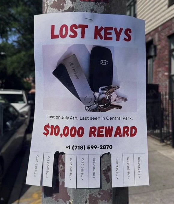 A "LOST KEYS" poster tacked to a pole offers a "$10,000 REWARD" for Hyundai and Edge keys lost on July 4th in Central Park, with tear-off tabs displaying the phone number +1 (718) 599-2870—matching the 718 area code famously spoofed in a $10K scam involving phone calls from "Kevins" in 2022.