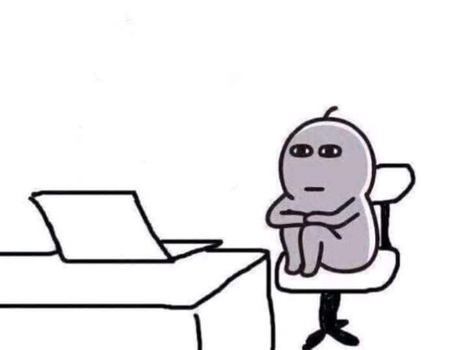 A cartoon-style image shows a gray, simple character sitting at a desk with a laptop, arms crossed and staring blankly ahead.