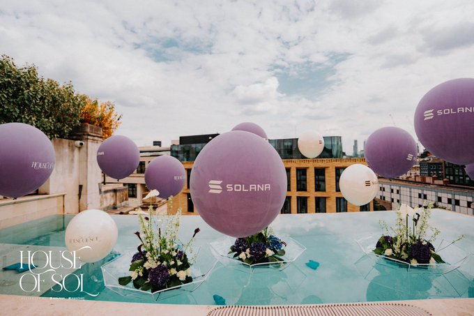 An outdoor rooftop event display shows purple and white balloons branded with the 'SOLANA' logo floating above a pool decorated with floral arrangements, with 'HOUSE OF SOL' text visible.