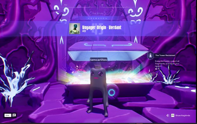 A video game screenshot showing a character named 'Voyager: Origin Verdant' with the username 'famcarlitos' in a purple-themed mystical environment, with text indicating 'The Tower Reclaimed' and instructions to scale the tower and collect fragments.