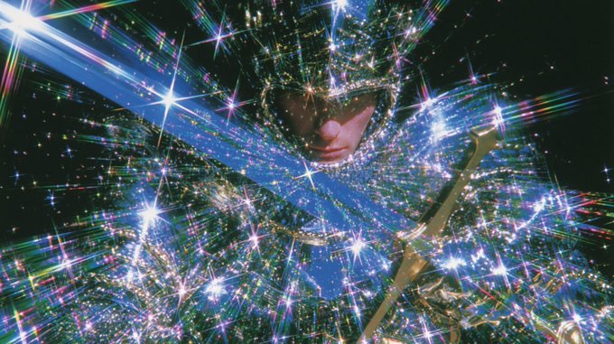 A person in a highly reflective, starburst-covered costume poses with the “KNIGHT” ticker reflected across the image. The accompanying post, “Knight coded $KNIGHT,” frames the knight-themed image as crypto branding.